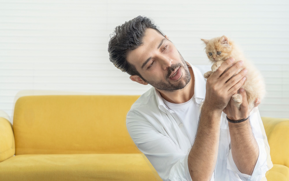 man-holding-kitten